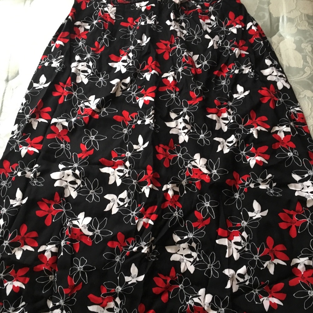 Black skirt with red and white flowers on it.